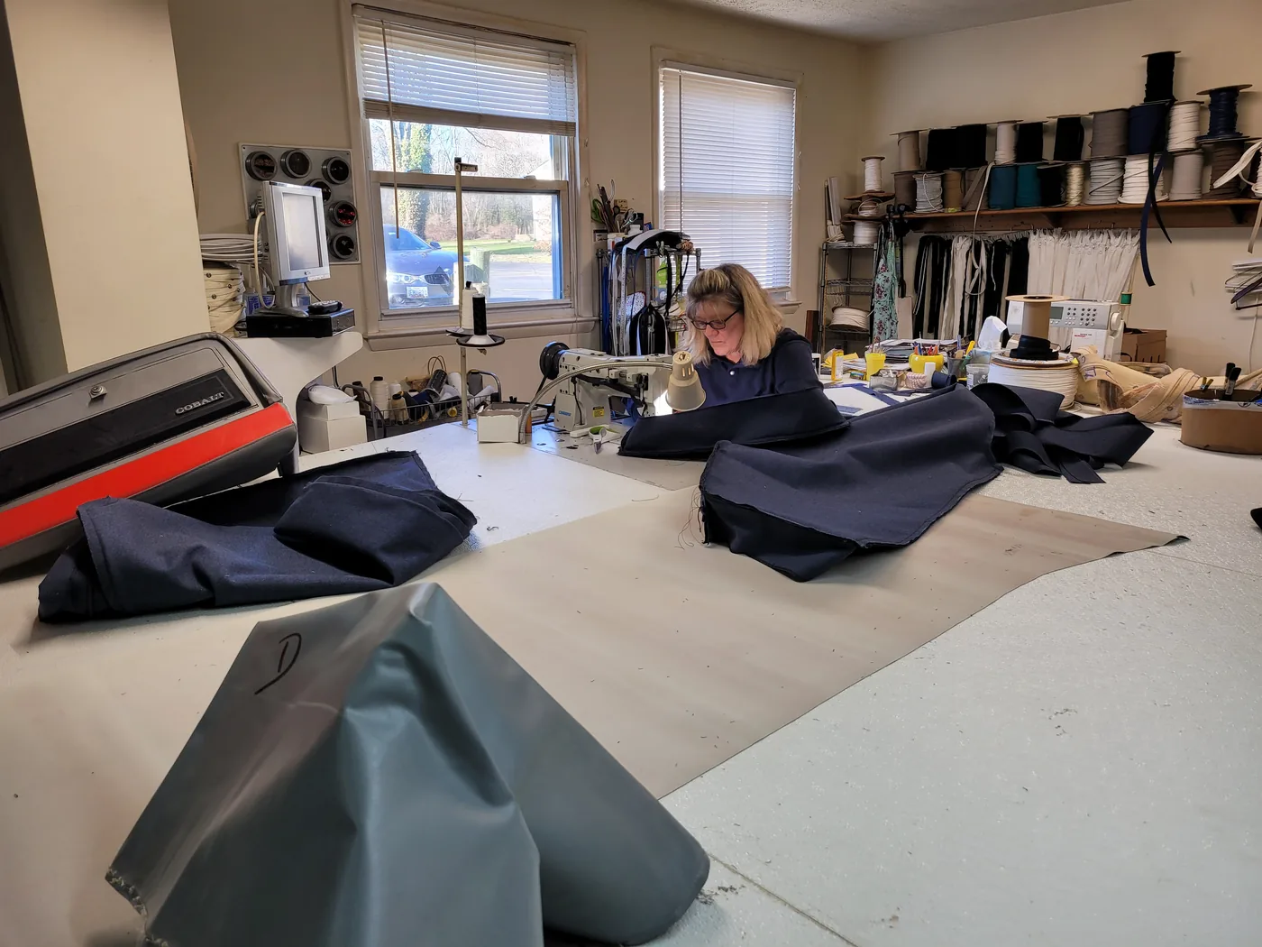 Joyce sewing in the shop